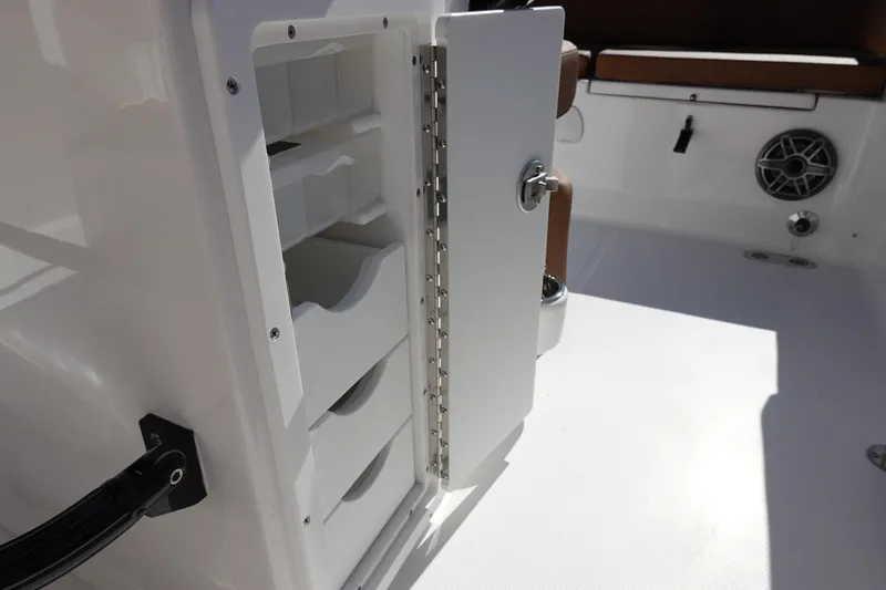 Slide: The Image of Open storage compartment on 2026 Sea Hunt Ultra 255 SE boat interior. - 18