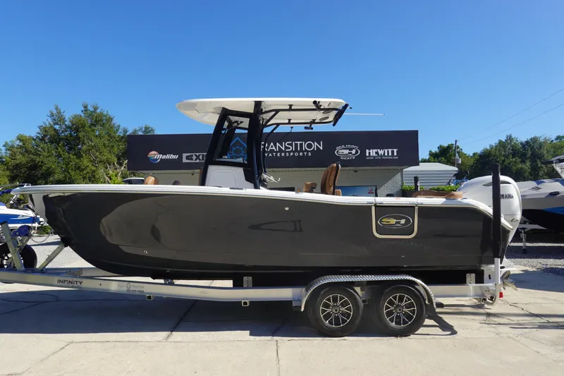 Slide: The Image of 2026 Sea Hunt Ultra 255 SE boat on trailer, displayed outdoors. - 2