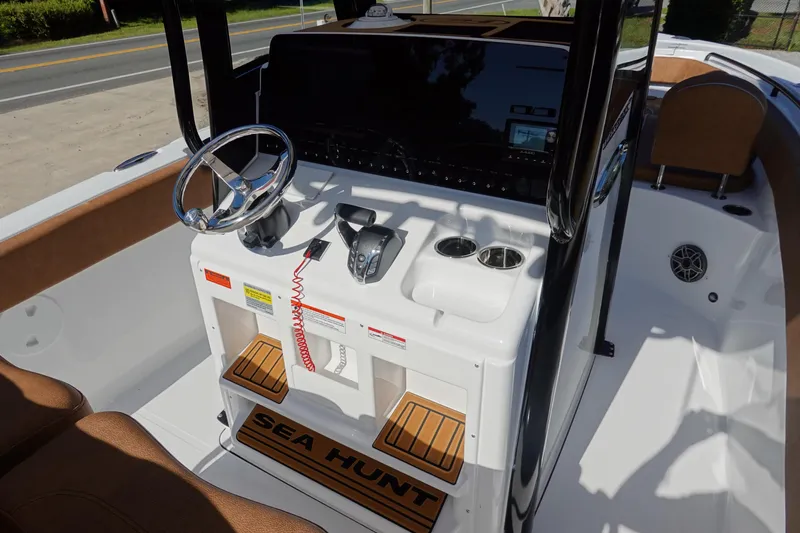 Slide: The Image of 2026 Sea Hunt Ultra 255 SE boat console with steering wheel and controls. - 20