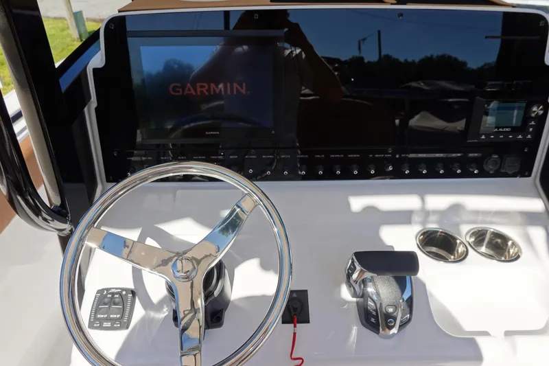 Slide: The Image of 2026 Sea Hunt Ultra 255 SE boat dashboard with Garmin display and steering wheel. - 22