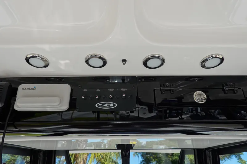 Slide: The Image of 2026 Sea Hunt Ultra 255 SE dashboard with Garmin equipment and control panel. - 24