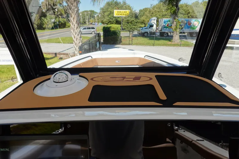 Slide: The Image of 2026 Sea Hunt Ultra 255 SE dashboard with compass, viewed from inside the boat. - 25