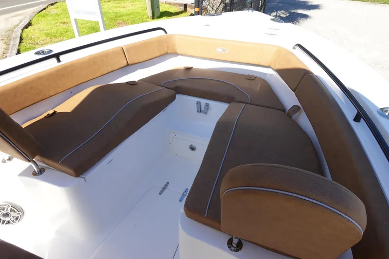 Slide: The Image of 2026 Sea Hunt Ultra 255 SE boat interior with brown cushioned seating. - 27
