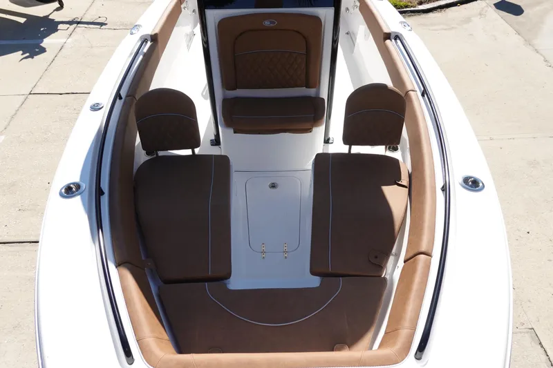 Slide: The Image of 2026 Sea Hunt Ultra 255 SE boat interior with brown cushioned seating. - 28