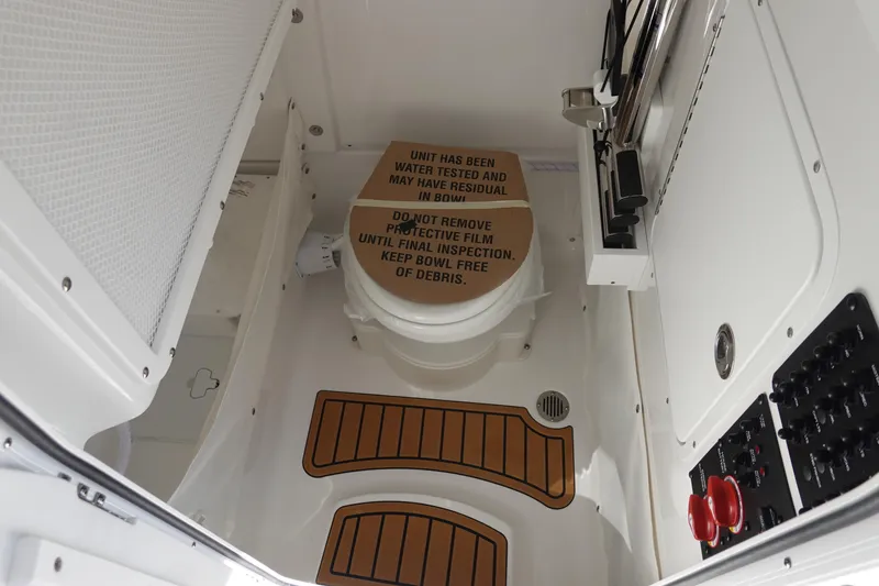 Slide: The Image of 2026 Sea Hunt Ultra 255 SE boat interior with toilet and control panel. - 32