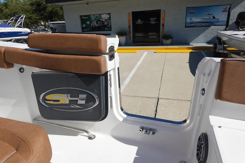 Slide: The Image of 2026 Sea Hunt Ultra 255 SE boat interior with brown seating and SH logo. - 33