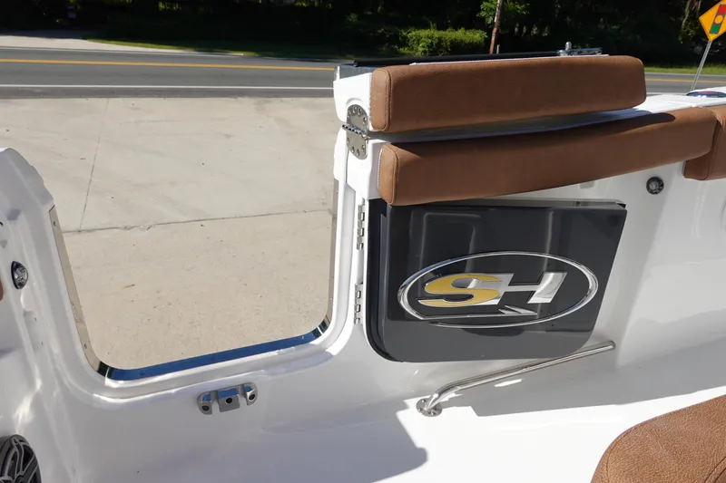 Slide: The Image of 2026 Sea Hunt Ultra 255 SE boat with open side door and brown seating. - 34