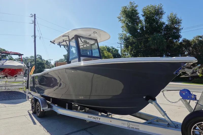 Slide: The Image of 2026 Sea Hunt Ultra 255 SE boat on trailer, displayed outdoors. - 5