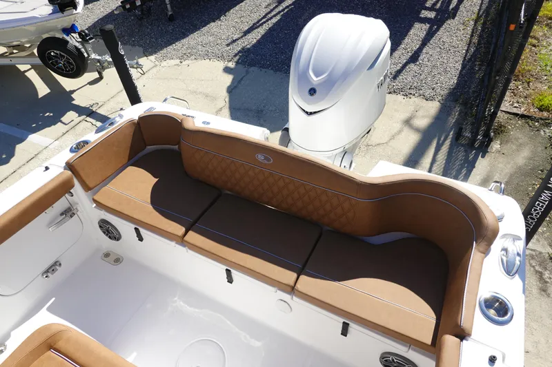 Slide: The Image of 2026 Sea Hunt Ultra 255 SE boat interior with tan seating and outboard motor. - 8