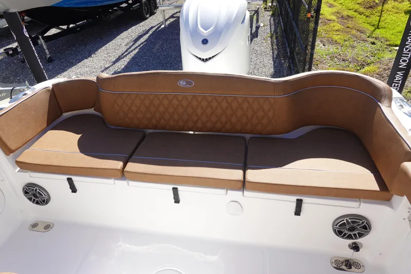 Slide: The Image of 2026 Sea Hunt Ultra 255 SE boat with brown cushioned seating and speakers. - 9