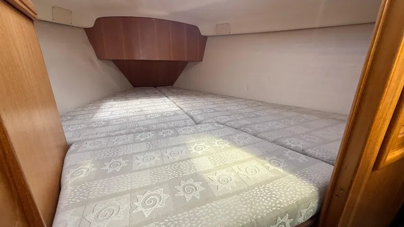 Slide: The Image of Cozy cabin interior of 2002 Hunter 326 sailboat with patterned bedding. - 13