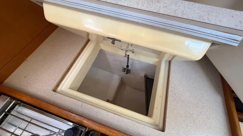 Slide: The Image of Open storage compartment in a 2002 Hunter 326 boat interior. - 17