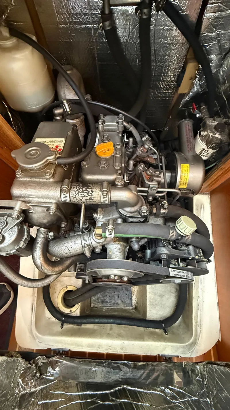 Slide: The Image of 2002 Hunter 326 engine compartment with visible components and hoses. - 20