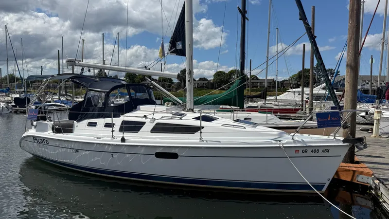 Slide: The Image of 2002 Hunter 326 sailboat docked at marina under cloudy sky. - 23