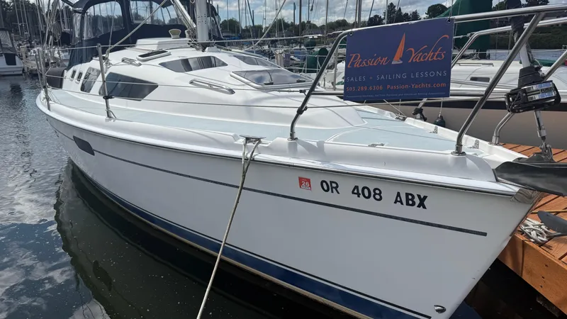 Slide: The Image of Hunter 326 sailboat from 2002 docked at marina, Passion Yachts sign visible. - 25