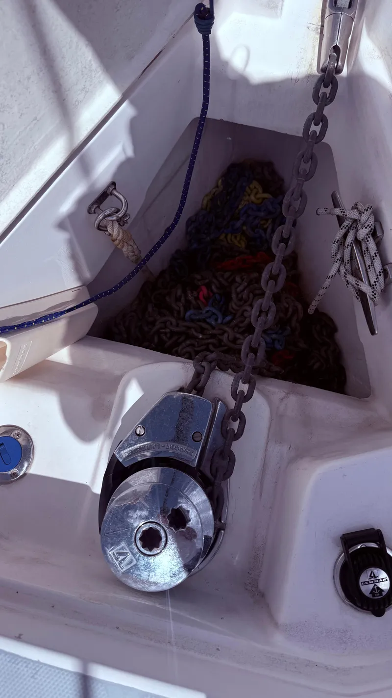 Slide: The Image of Anchor chain and winch on a 2002 Hunter 326 sailboat deck. - 27