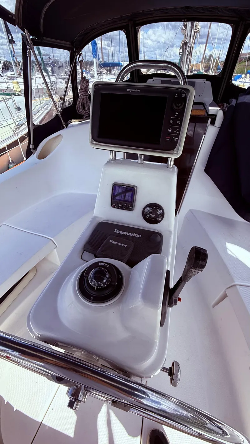 Slide: The Image of Cockpit of 2002 Hunter 326 sailboat with navigation equipment and steering wheel. - 31