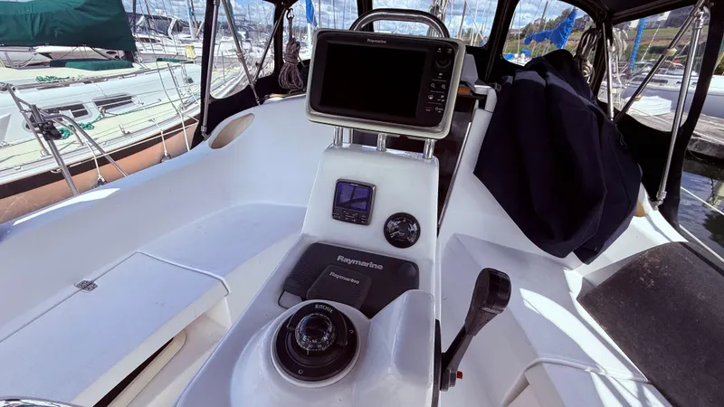 Slide: The Image of Cockpit of 2002 Hunter 326 sailboat with navigation equipment and steering wheel. - 32