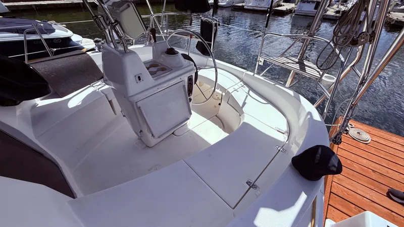 Slide: The Image of 2002 Hunter 326 sailboat cockpit with steering wheel and seating at marina. - 33