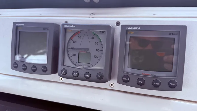 Slide: The Image of Raymarine instrument panel on a 2002 Hunter 326 sailboat, displaying depth, wind, and speed. - 35