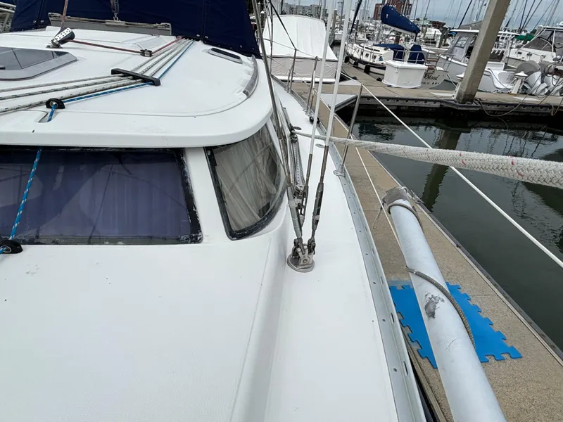 Slide: The Image of 2001 Jeanneau Sun Odyssey 43 DS sailboat docked at marina, showcasing deck and rigging. - 17