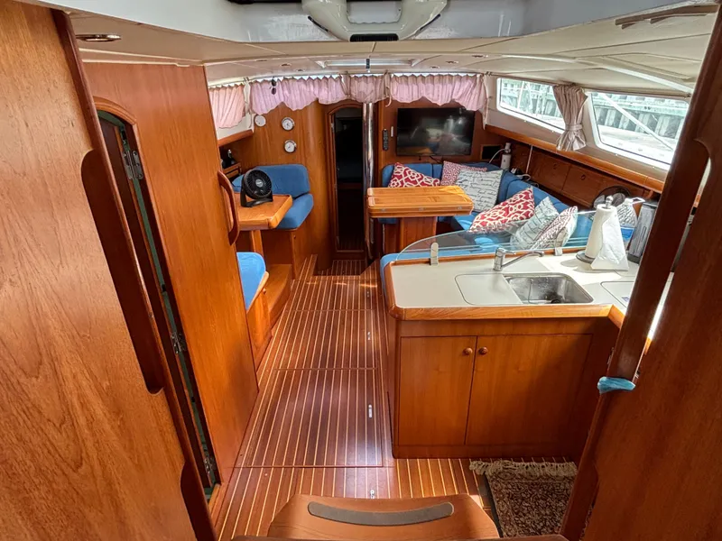 Slide: The Image of Interior of 2001 Jeanneau Sun Odyssey 43 DS yacht with wood finish and cozy seating area. - 22