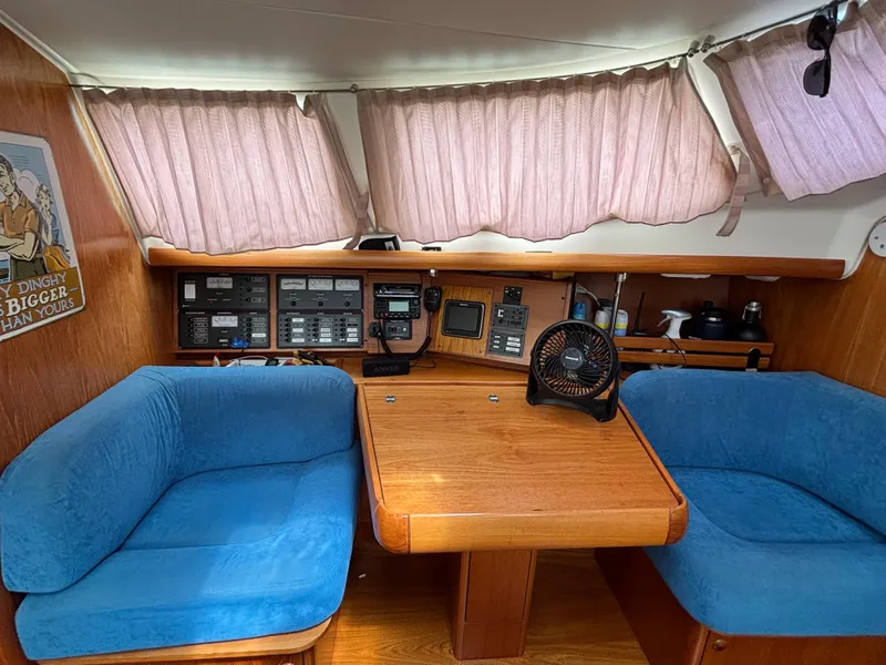 Slide: The Image of Interior of 2001 Jeanneau Sun Odyssey 43 DS with blue seating and navigation equipment. - 25