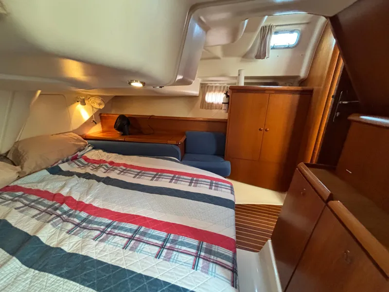 Slide: The Image of Interior cabin of 2001 Jeanneau Sun Odyssey 43 DS yacht, featuring bed and wooden cabinetry. - 36