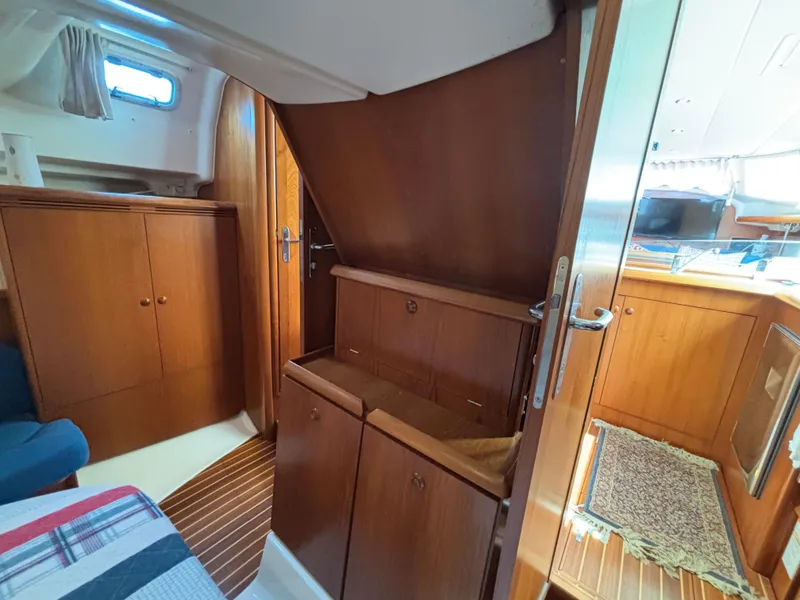 Slide: The Image of Interior of 2001 Jeanneau Sun Odyssey 43 DS sailboat, featuring wooden cabinetry and cozy design. - 37