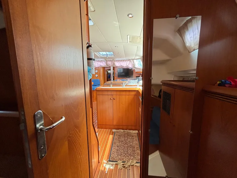 Slide: The Image of Interior of 2001 Jeanneau Sun Odyssey 43 DS sailboat, featuring wooden cabinetry and cozy layout. - 38