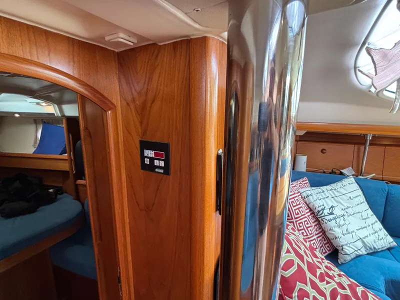 Slide: The Image of Interior of 2001 Jeanneau Sun Odyssey 43 DS sailboat with wood paneling and cozy seating. - 43