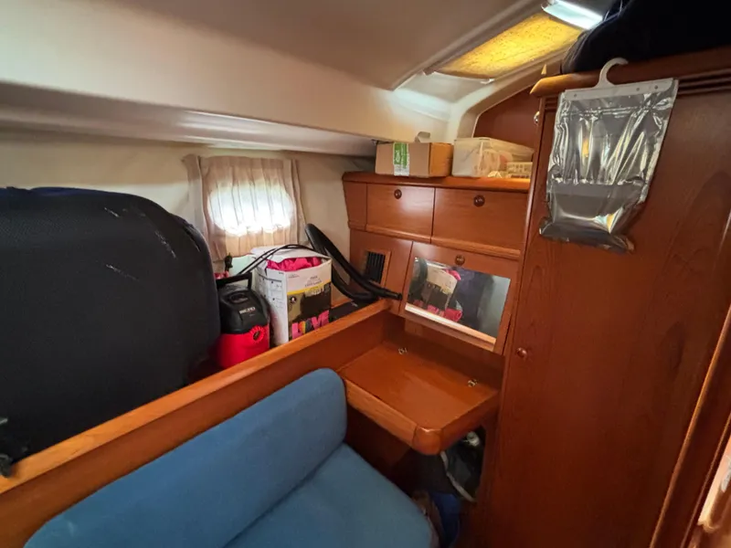Slide: The Image of Cozy cabin interior of 2001 Jeanneau Sun Odyssey 43 DS sailboat with storage and seating. - 45