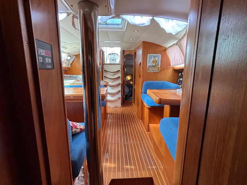 Slide: The Image of Interior of 2001 Jeanneau Sun Odyssey 43 DS sailboat with wood finish and blue seating. - 46