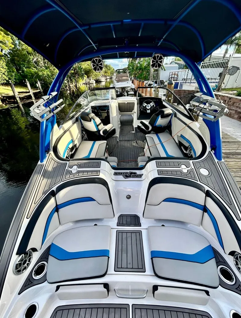Slide: The Image of 2018 Yamaha Boats 242X E-Series with sleek interior, blue accents, and advanced features. - 12