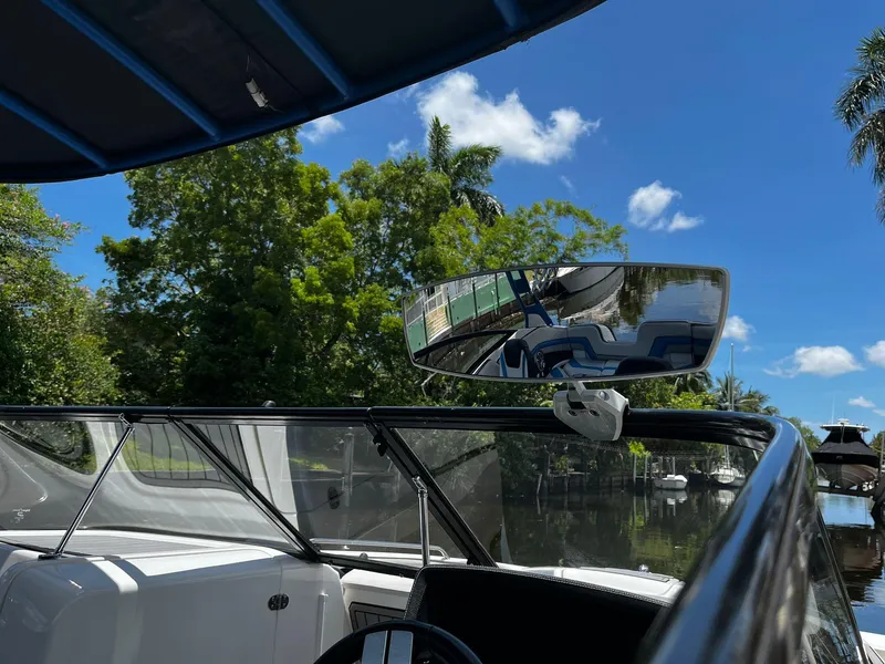 Slide: The Image of 2018 Yamaha Boats 242X E-Series on a sunny day, featuring sleek design and lush surroundings. - 16