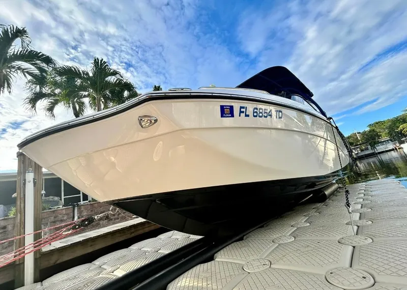 Slide: The Image of 2018 Yamaha Boats 242X E-Series on dock, tropical setting, clear sky. - 5