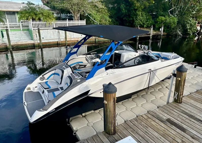 Slide: The Image of 2018 Yamaha Boats 242X E-Series docked on a calm waterfront. - 8