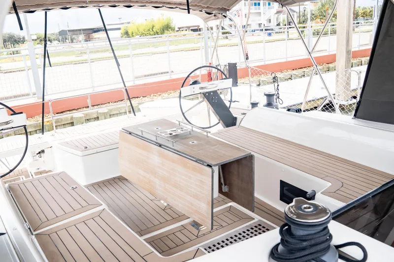 Slide: The Image of 2023 Dufour 530 yacht cockpit with dual steering wheels and teak decking. - 15