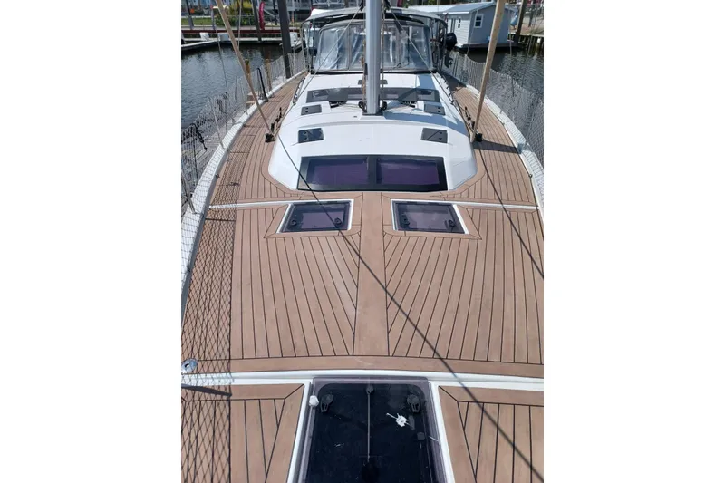 Slide: The Image of 2023 Dufour 530 sailboat deck with sleek wood finish and modern design. - 25