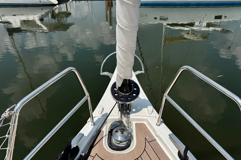 Slide: The Image of Bow of 2023 Dufour 530 yacht with polished deck and railing reflections. - 28