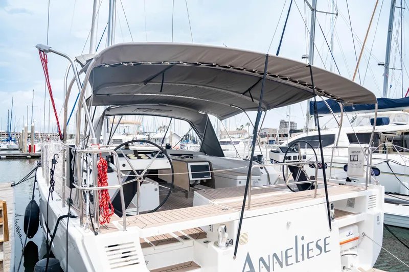 Slide: The Image of 2023 Dufour 530 yacht docked at marina, featuring spacious cockpit and modern design. - 3