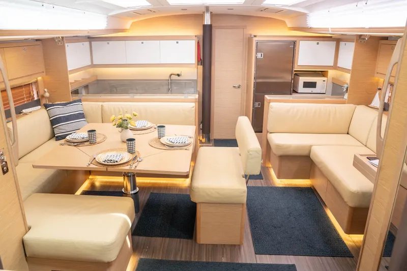 Slide: The Image of Luxurious interior of 2023 Dufour 530 yacht with elegant dining area and modern kitchen amenities. - 30