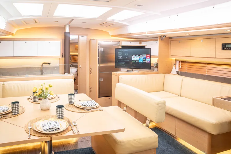 Slide: The Image of Luxurious interior of 2023 Dufour 530 yacht with modern dining and entertainment area. - 31