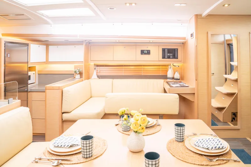 Slide: The Image of Luxurious interior of 2023 Dufour 530 yacht with modern kitchen and dining area. - 32