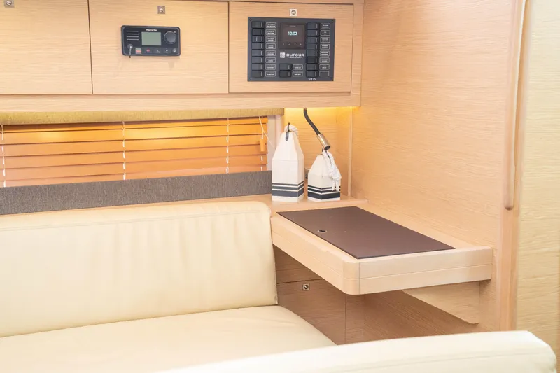 Slide: The Image of Interior of 2023 Dufour 530 yacht with modern navigation panel and cozy seating area. - 37
