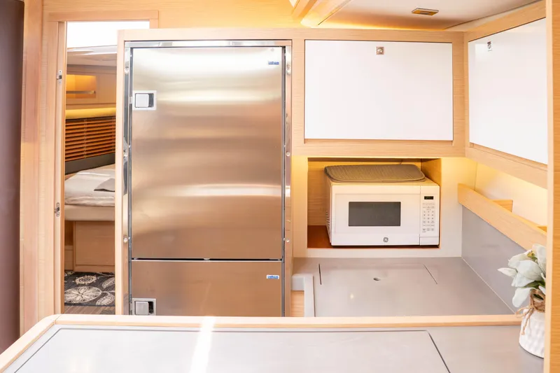 Slide: The Image of Modern kitchen in 2023 Dufour 530 yacht with stainless steel fridge and microwave. - 43