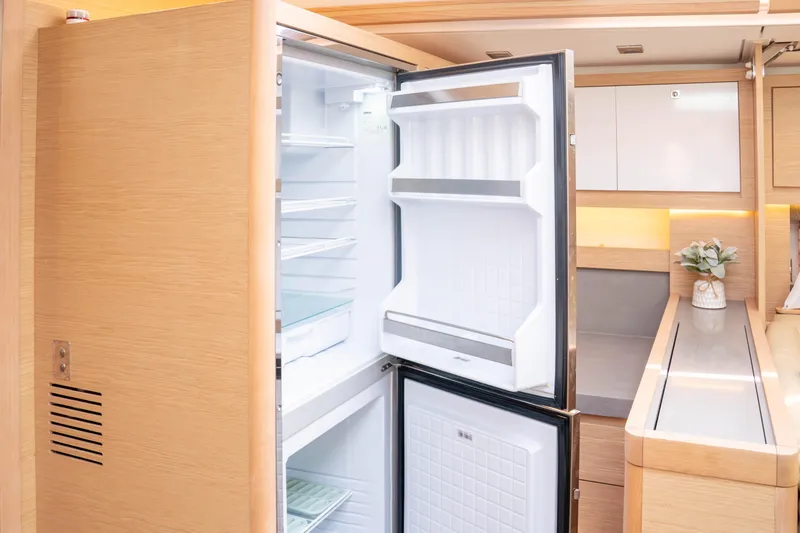 Slide: The Image of Modern kitchen interior of 2023 Dufour 530 yacht with open refrigerator. - 45