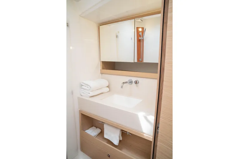 Slide: The Image of Modern bathroom interior on 2023 Dufour 530 yacht, featuring sleek sink and mirror. - 48