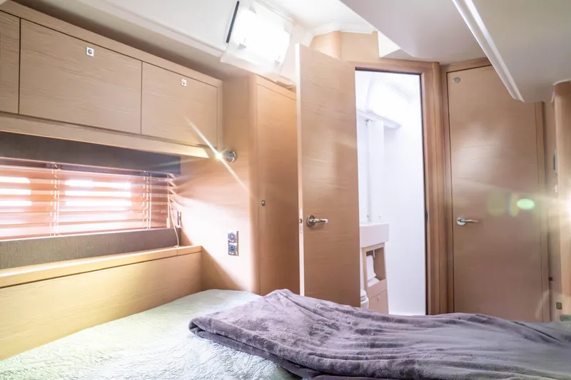 Slide: The Image of Luxurious interior of 2023 Dufour 530 yacht cabin with modern wood finish. - 50