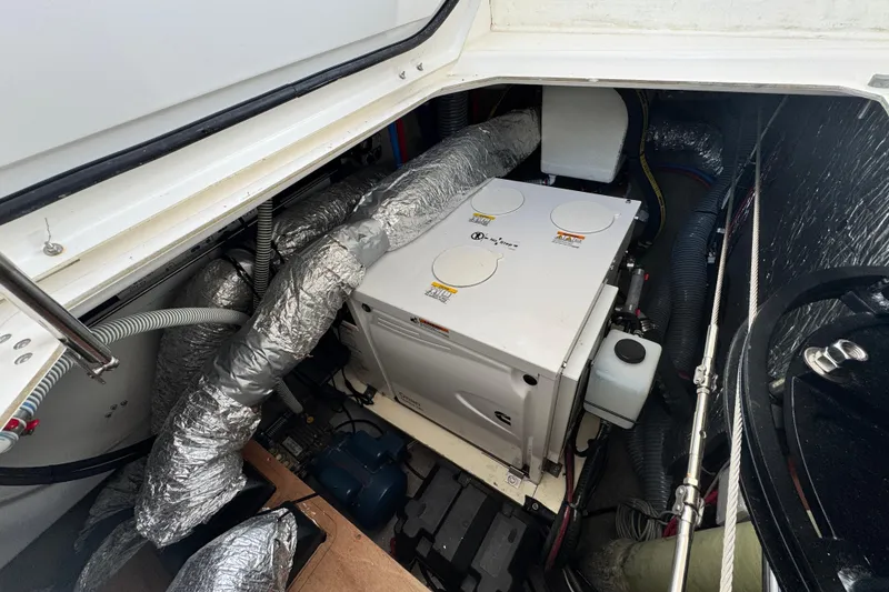 Slide: The Image of Engine compartment of 2023 Dufour 530 yacht with visible machinery and ductwork. - 59